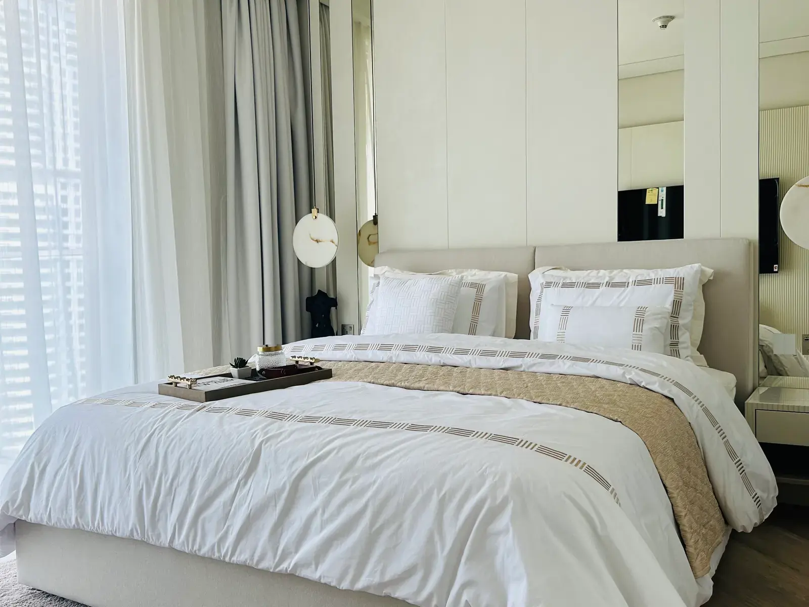 Principal bedroom with fluted wall panelling and pendants dropped either side of the bed