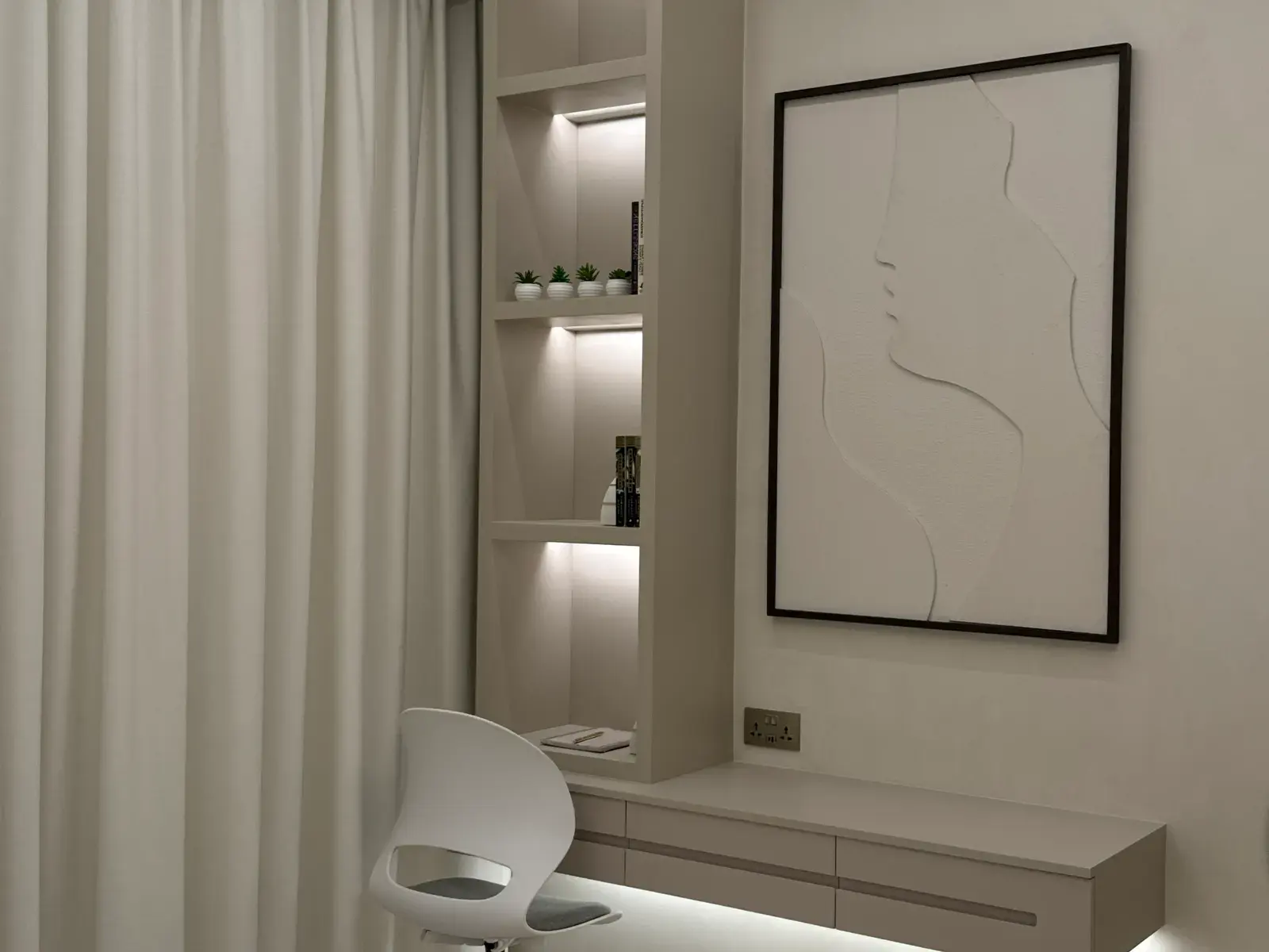 Dressing nook with lit display shelving and a wall-hung desk