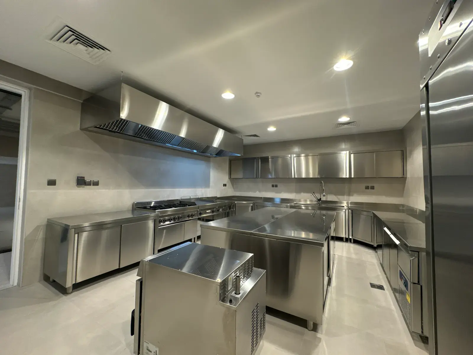 Stainless steel prep kitchen with commercial-grade counters and extraction