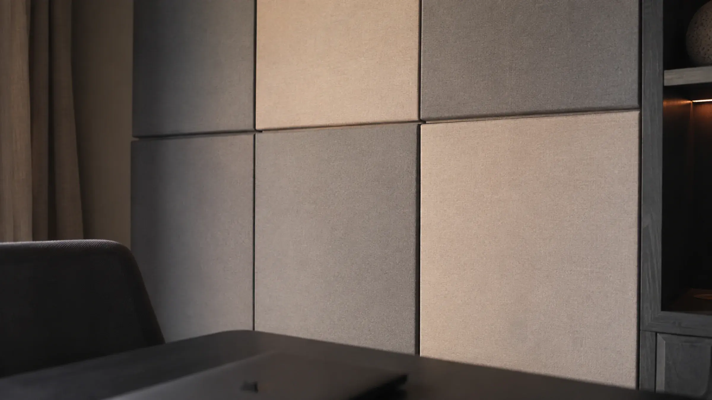 Fabric-wrapped acoustic panels in two tones behind a home office desk, warm raking light showing the fabric texture