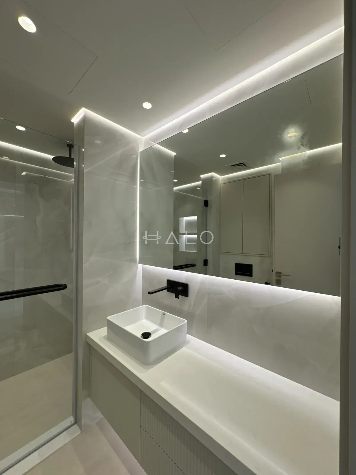 Bathroom vanity and mirrored wall — Burj Vista, Halo Interiors