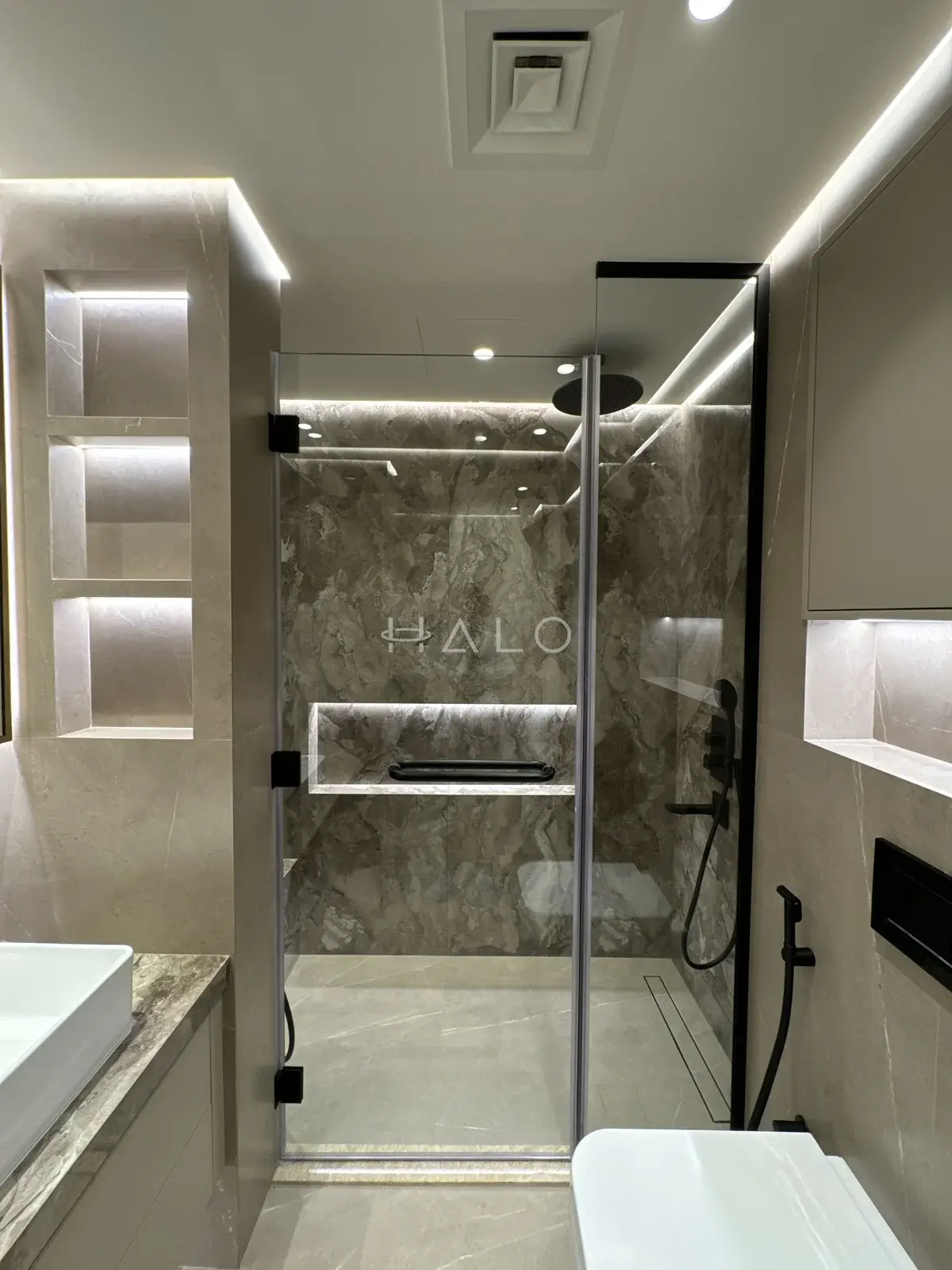 Bathroom storage shelves and shower — Burj Vista, Halo Interiors