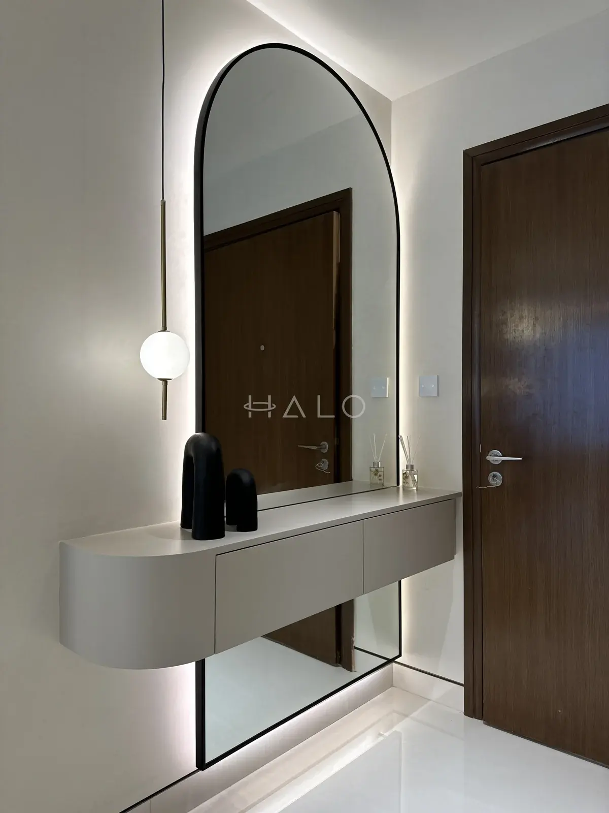 Entryway console and arched mirror — Forte Tower, Halo Interiors