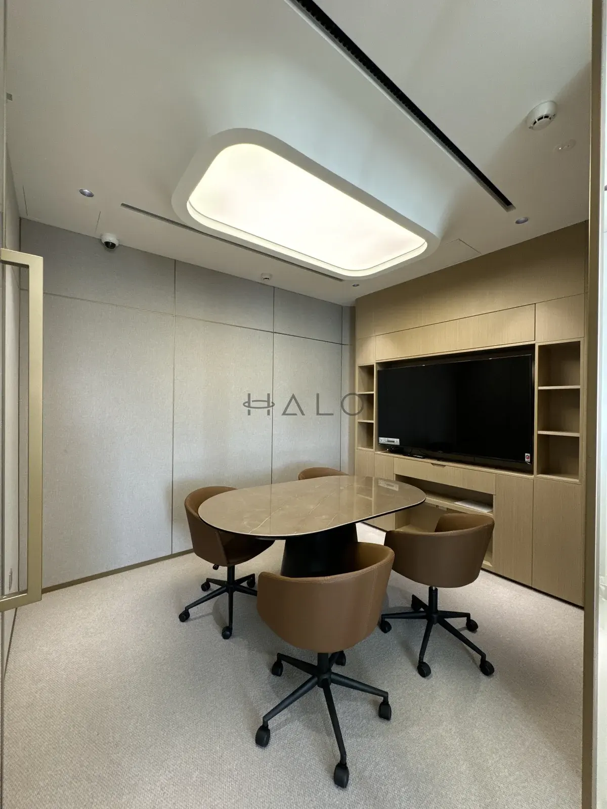 Meeting table and tv wall cabinetry — USH / Nshama, Halo Interiors