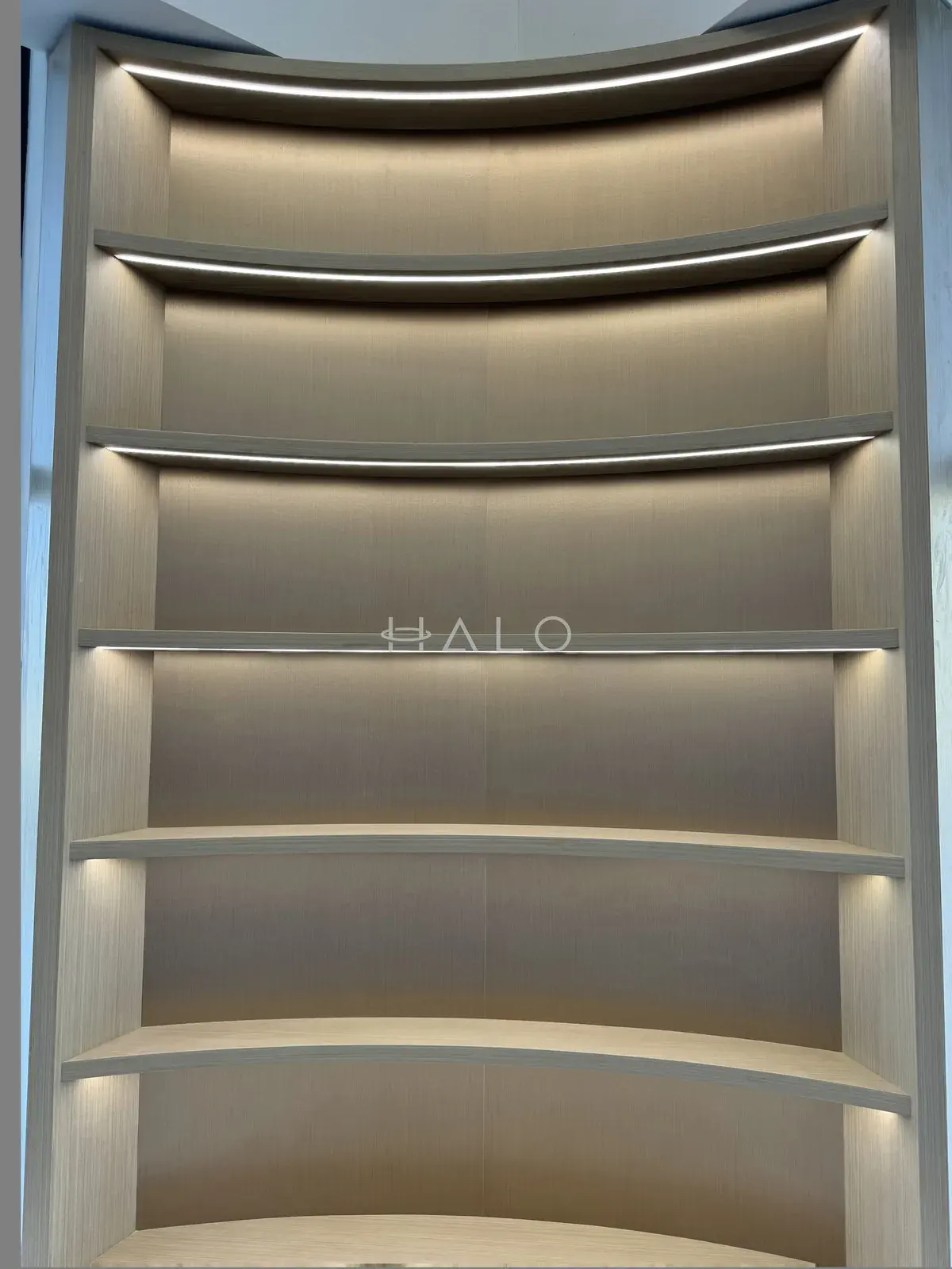 Curved illuminated display shelves — USH / Nshama, Halo Interiors