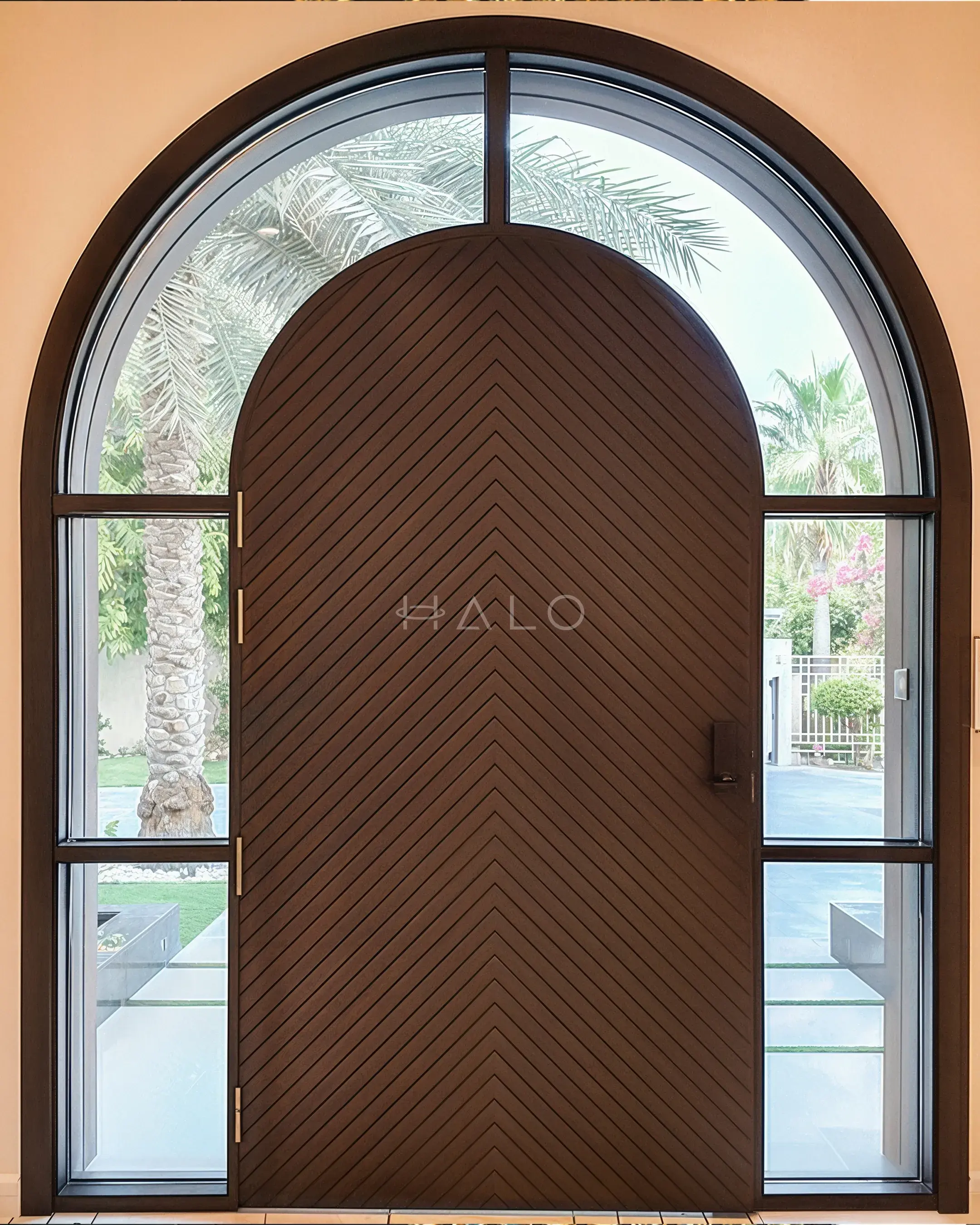 Arched timber main door with chevron grain and a glazed arch fanlight on a Dubai villa entrance