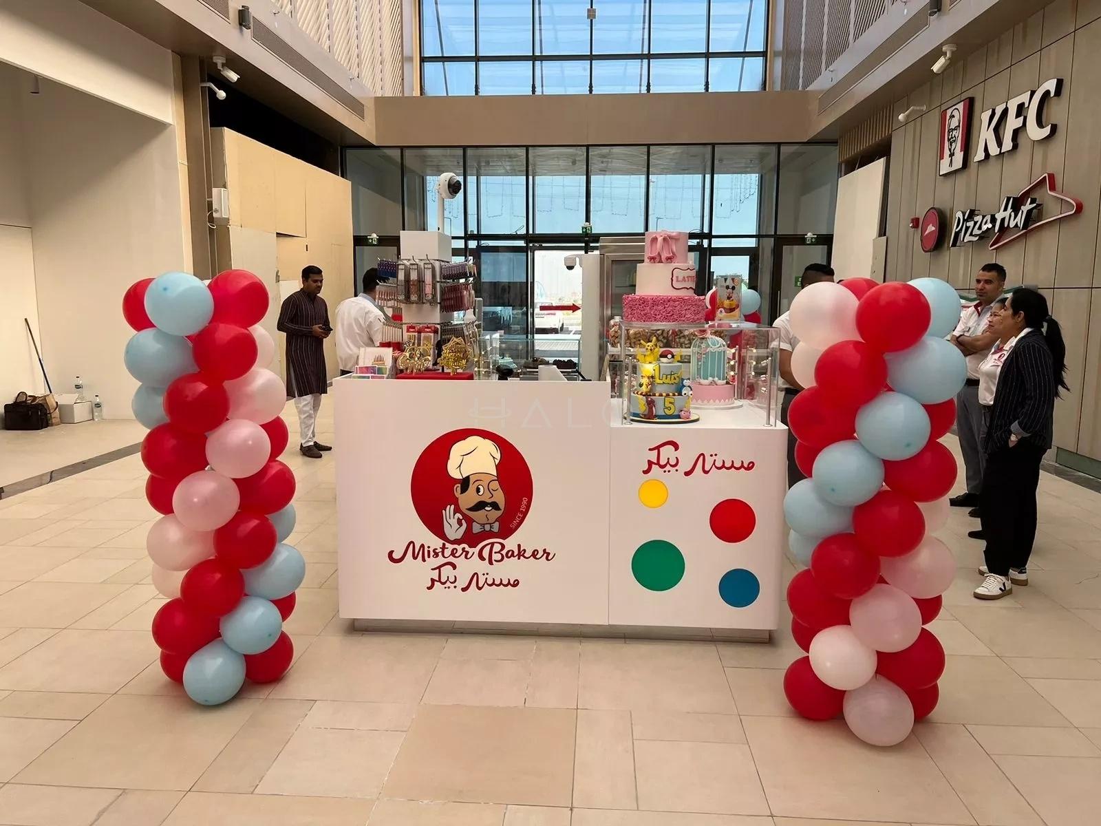 Mall atrium brand activation with a branded serving counter and event dressing in Dubai