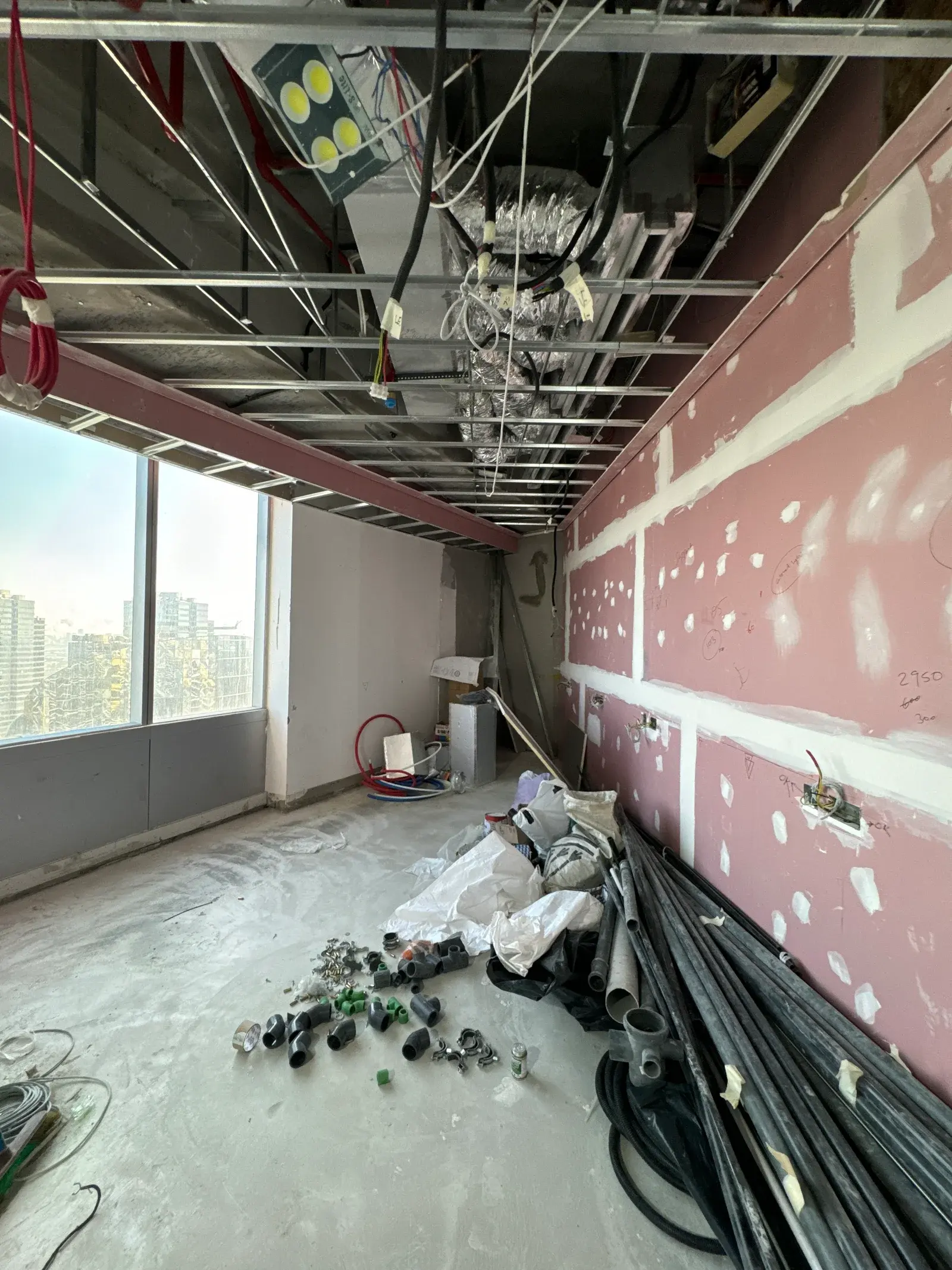 Conduit, boxes and cable staged on the floor at electrical first fix in a Dubai commercial unit