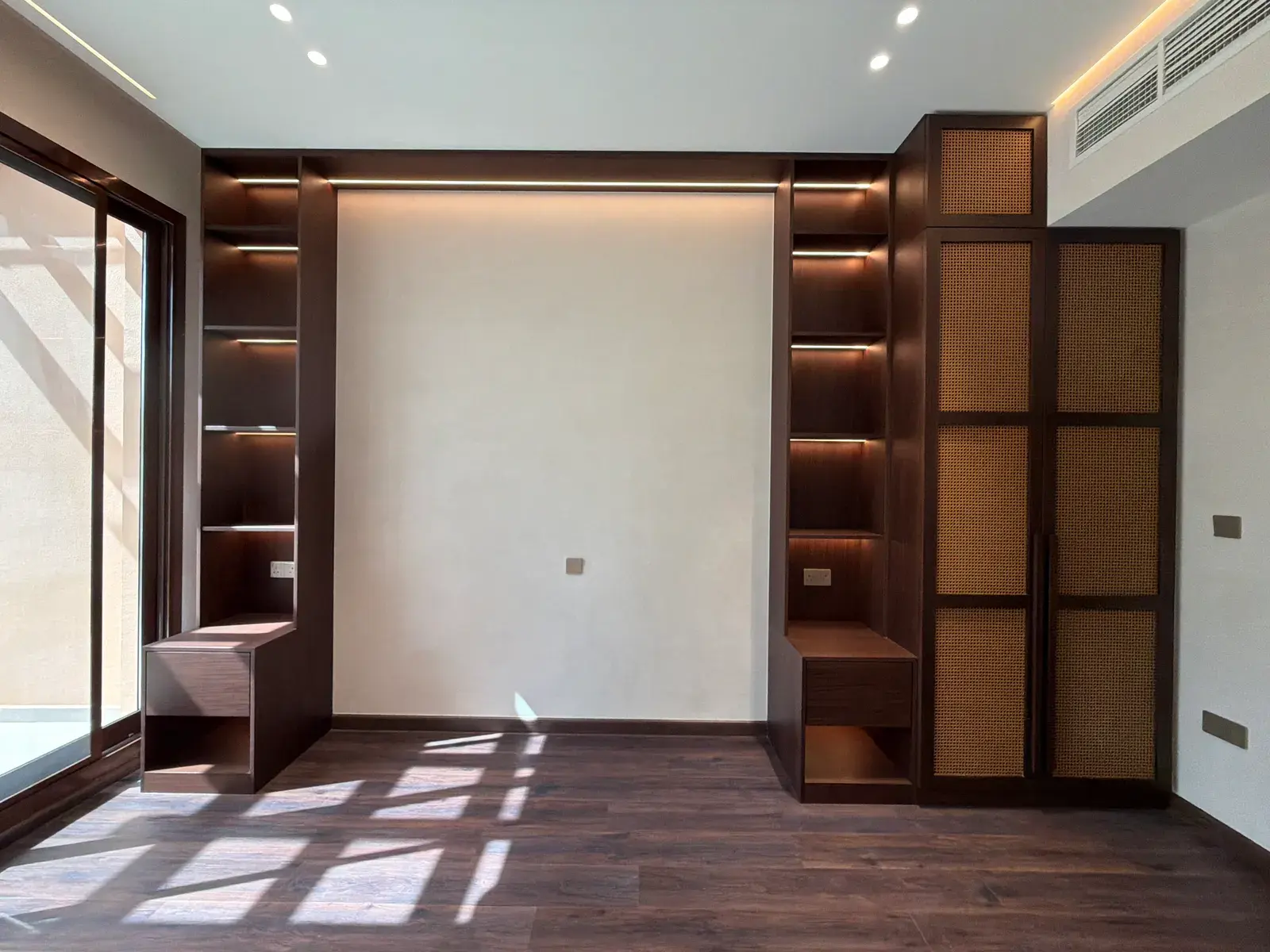 Bedroom with cane screen, walnut joinery and timber flooring