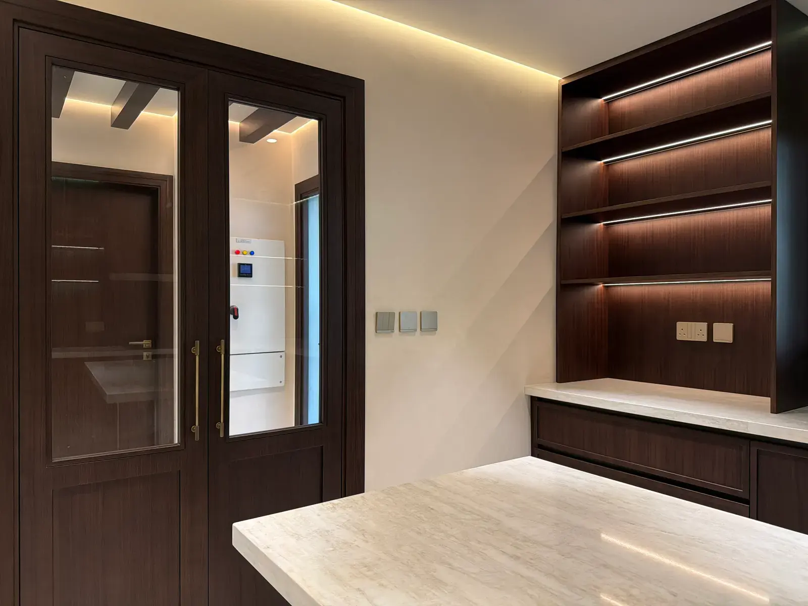 Landing with walnut shelving and glazed walnut doors