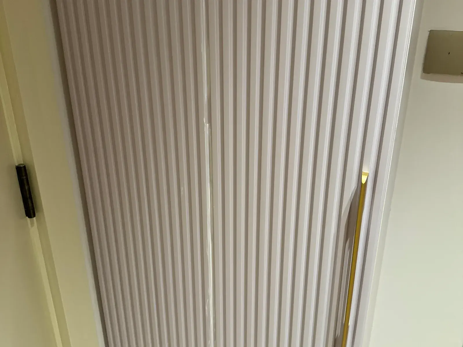 Fluted joinery door with a slim brass pull
