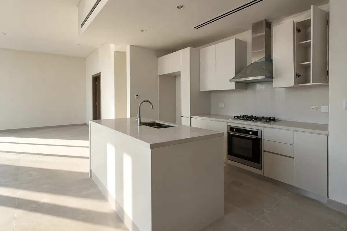 Newly handed-over penthouse kitchen with plain developer-standard finishes