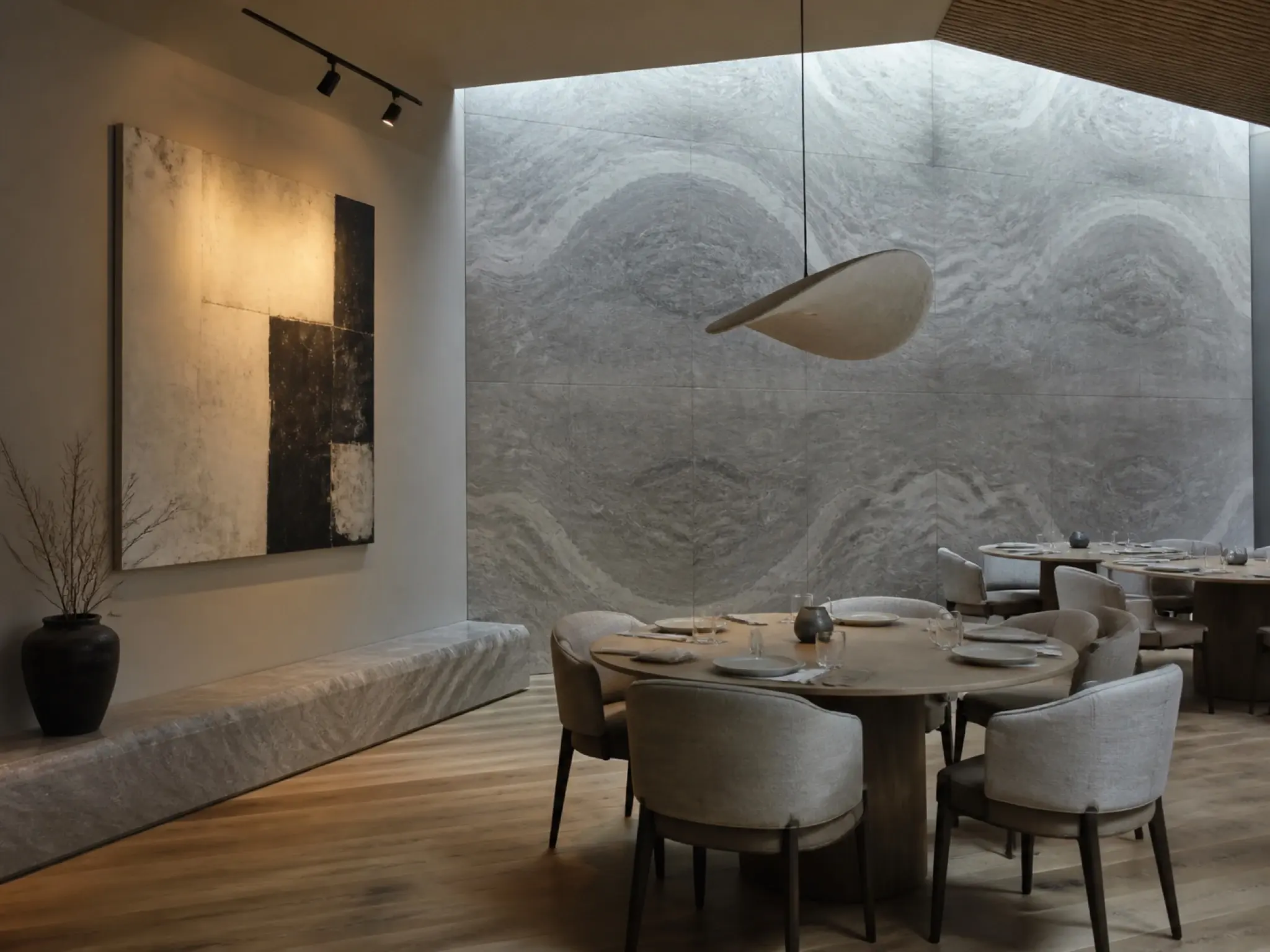 Contemporary gallery-style restaurant with stone surfaces, sculptural lighting and curated artwork