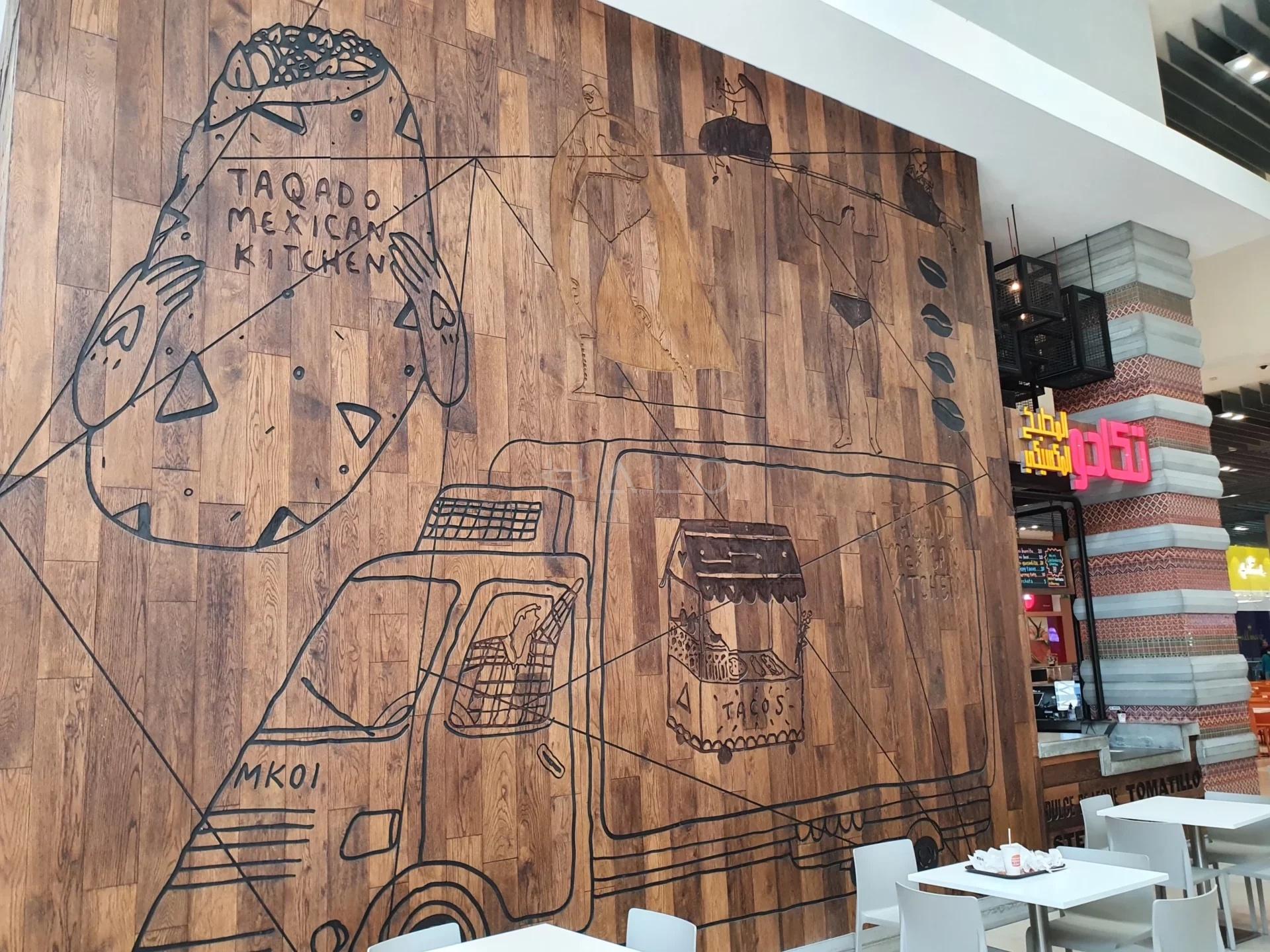 Completed restaurant fit-out with dining seating and feature wall in Dubai — portfolio view 01