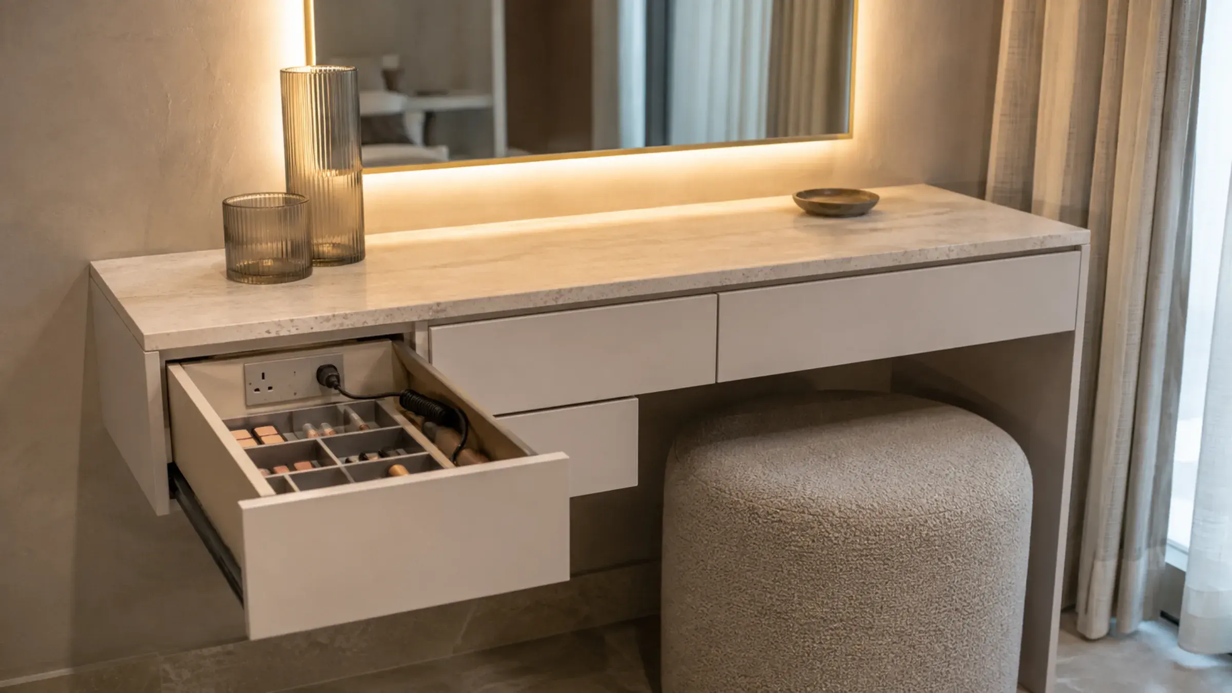 Seated dressing table with a boucle stool and an open powered organiser drawer