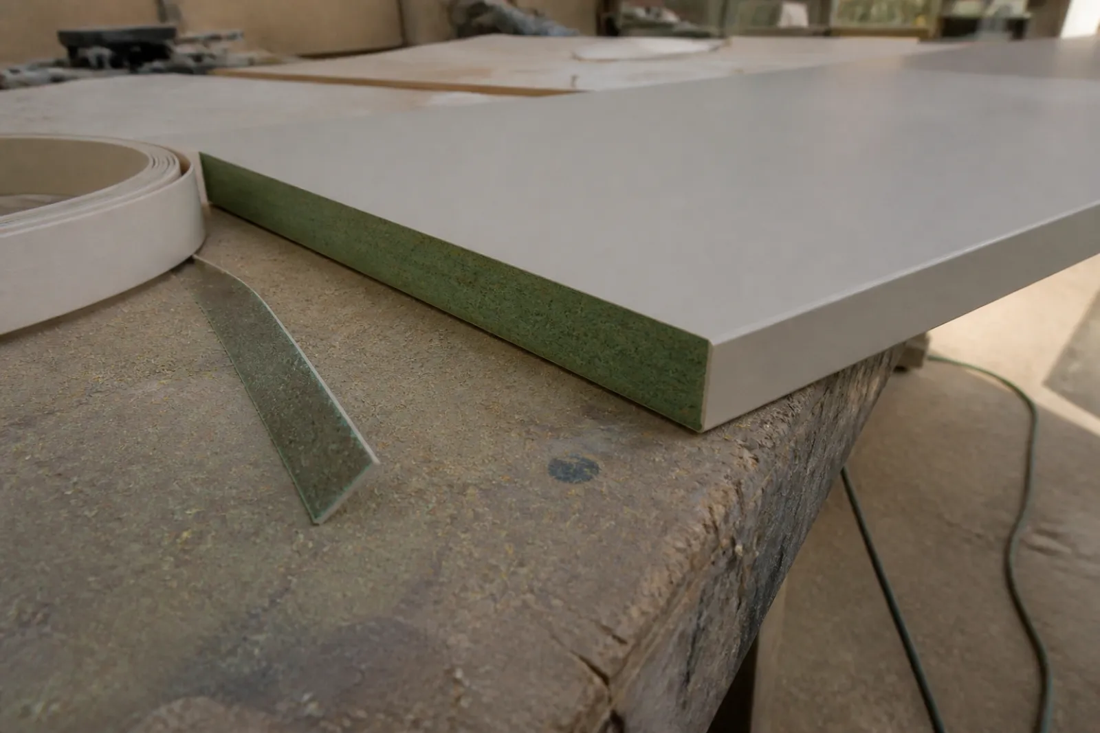 Moisture-resistant MDF core beside a thick edge band on the workshop bench