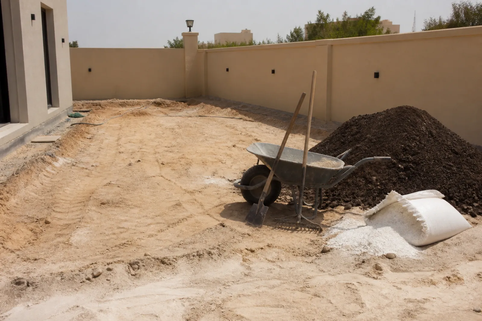 Ground preparation and soil amendment in a Dubai villa garden