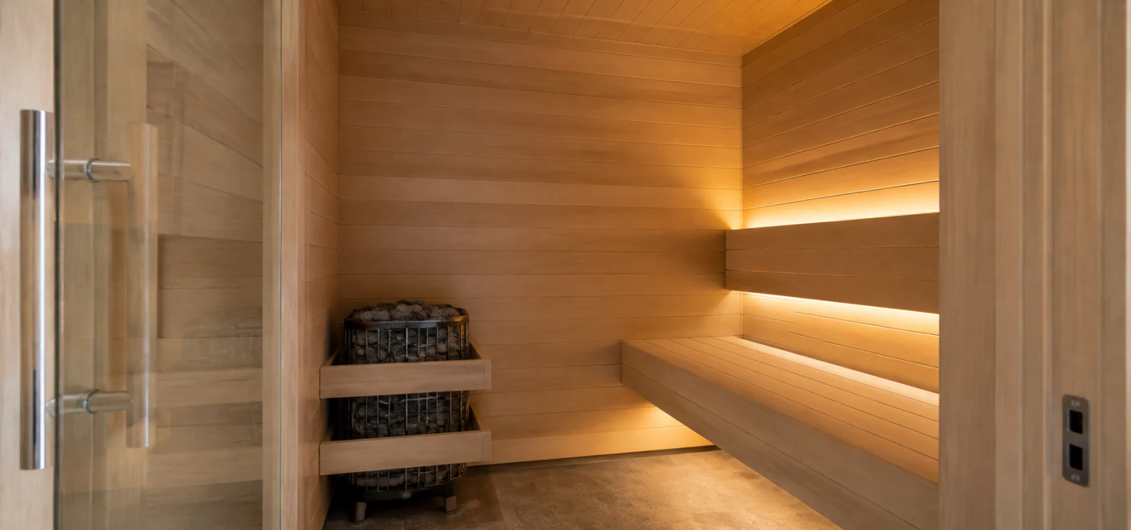 Home sauna interior with timber cladding, heater and ambient lighting in a Dubai residence